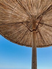 Underneath a Straw Beach Umbrella