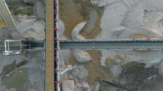 Stacker conveyors pile processed rock, ore, and sediment for loading onto trucks.