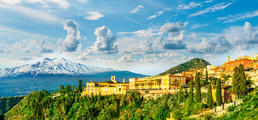 beautiful landscape of Taormina town, Italy, Sicily with scenic view at San Domenico hotel near nice buildings and panoramic view of Etna mountain on background