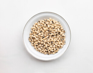 Yellow Beans Arranged in Ceramic Plate Resting on White Background Representing Healthy Food and Nutrition Concept