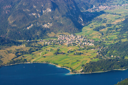Aerial view of Bohinj lake, Stara Fuzina, Srednja Vas v Bohinju and Studor v Bohinju villages and surrounding cultivated fields, forests and mountains in Gorenjska, Slovenia, seen from Vogel