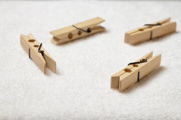 Wooden clothespins on textured fabric with natural light