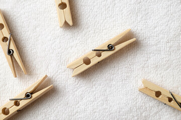 Crafting joy with rustic wooden clothespins scattered on soft fabric