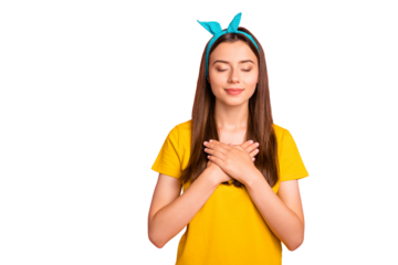 Portrait of charming lady with her eyes closed putting hands on chest wearing yellow t-shirt blue headband isolated over pink background
