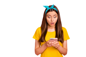 Portrait of impressed youth holding device looking wearing yellow t-shirt isolated over pink background