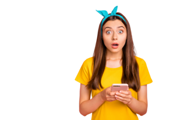 Portrait of astonished girl holding her gadget staring wearing yellow t-shirt isolated over pink background
