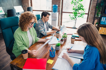 Group of colleagues working together at an office, collaborating on projects, exchanging ideas, and fostering teamwork