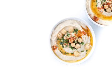 Chickpea hummus with olive oil, parsley and paprika in bowl isolated on white background. Top view. Copy space