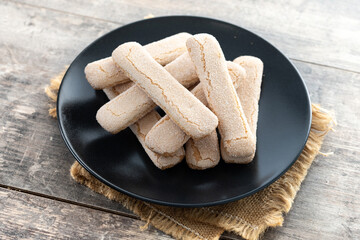 Italian biscuits ladyfingers savoiardi on wooden table