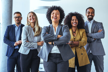 Smiling Group of Professionals Standing Together in a Modern Office Setting