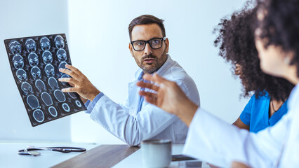 Medical Team Examining Brain Images During a Collaborative Discussion