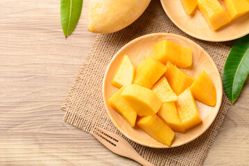 Cube mango on wooden plate ready to eating, Tropical fruit in summer season, Table top view