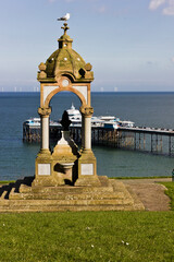 Coastal scene featuring the Queen Victoria Memorial & Fountain in Happy Valley with Llandudno Pier behind, Llandundo, Creuddyn Peninsula, North Wales