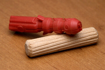 Unique red sculpture resting on wooden surface