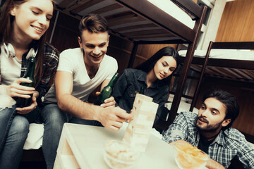 side photo of Friends playing in jenga Together.