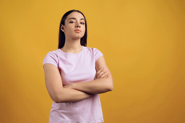 Obraz premium Portrait of pompous young girl with arms crossed