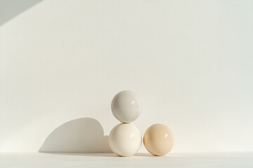 Three eggs in soft hues create serene ambiance against minimalis