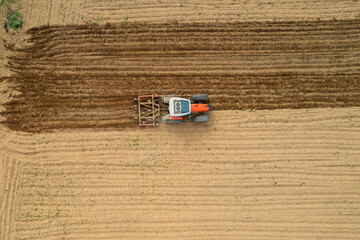 An aerial view of a Tractor tilling a field in the spring. Spring field work on a tractor © Bohdan