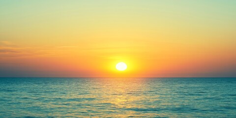 Fototapeta premium Sunset over a calm ocean. The image highlights the beauty of nature, peace and tranquility on a summer night. Summer sunset.