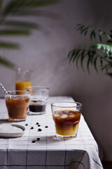Refreshing bumble coffee, orange juice espresso, iced orange juice coffee on a wooden table with coffee beans around, summer concept