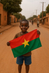 Young boy smiles widely as he proudly displays the national flag of Burkina Faso. The vibrant colors contrast against the dusty street and calm surroundings of his village Generative AI