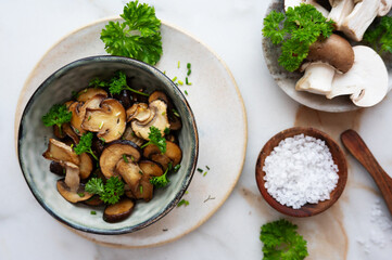 Homemade fried champignon mushrooms in a bowl.