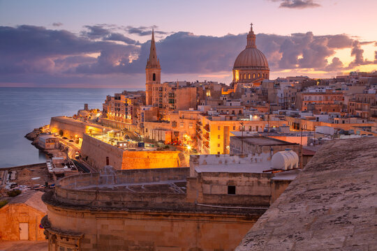 Valletta, Malta. Cityscape image of historical old town of Valletta, Malta with Basilica of Our Lady of Mount Carmel at beautiful autumn sunrise.