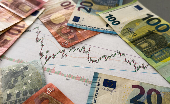 The concept of the fall and growth of the euro exchange rate. One hundred euro on a blue chart background.