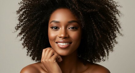 Smiling Afro-American woman with natural curls in soft lighting