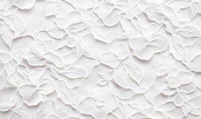 Close-up of beautiful white floral lace fabric with an intricate, delicate pattern.