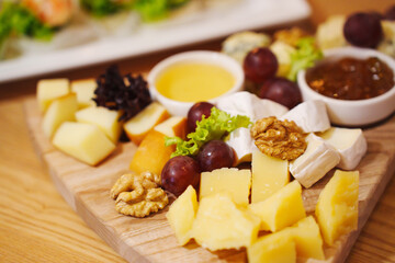 Cheese and fruit platter served at a cozy restaurant during evening hours