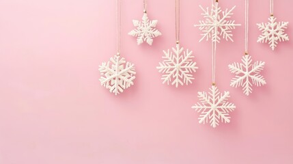 Delicate snowflakes on a soft pink canvas: a gentle winter's whisper.