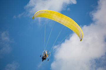 Motor glider flying in the blue sky