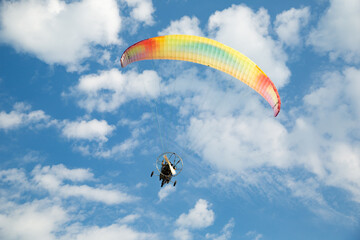 Motor glider flying in the blue sky