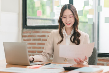 Professional woman analyzes data and creates reports at modern office workspace