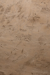 Rough brown decorative plaster creating a textured surface