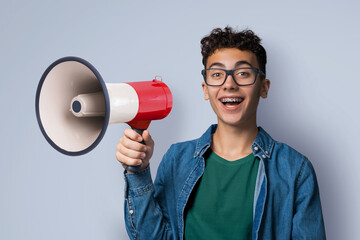 Funny very happy brunette hair young man wear glasses dent dental tooth braces brackets advertise...