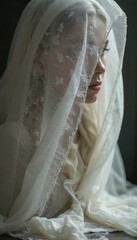 Bride in white veil with delicate lace in soft light conveying elegance and serenity