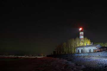 View of the old Shepelevso lighthouse on a March night. Leningrad region, Russia
