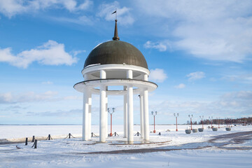 A round gazebo on the city embankment on a sunny March day. Petrozavodsk, Karelia. Russia
