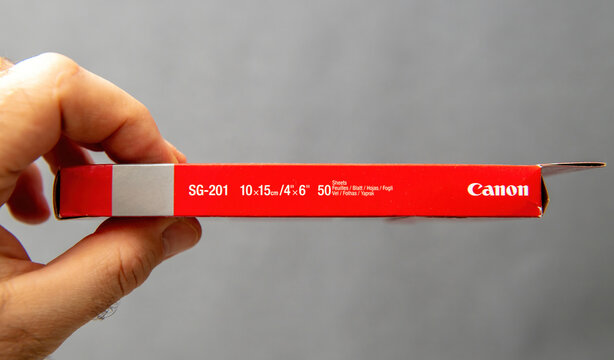 Paris, France - Mar 10, 2025: Close-up side view of Canon Photo Paper Plus SG-201 box showing label details of 10x15 cm satin sheets with product name and Canon branding printed on red edge