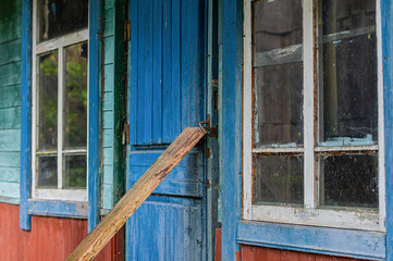 Abandoned House with Boarded Blue Door. Close up.