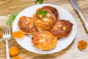 Appetizing cheese pancakes with a golden crust and a drop of honey