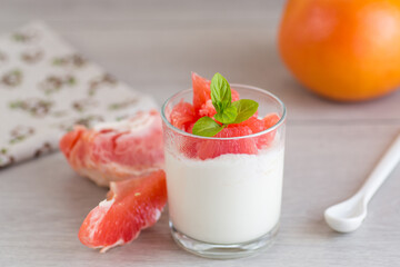 Creamy yogurt with juicy pieces of red grapefruit