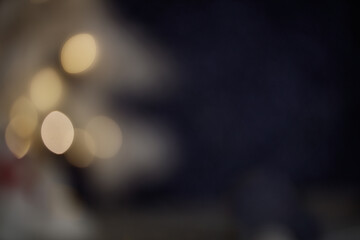 Festive bokeh effect showcasing twinkling christmas lights glowing softly against dark background, delivering magical holiday ambiance for seasonal design elements