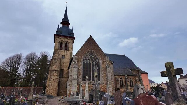 Saint Meen le Grand, abbey church and cemetery, cloudy sky in background, Brittany in France