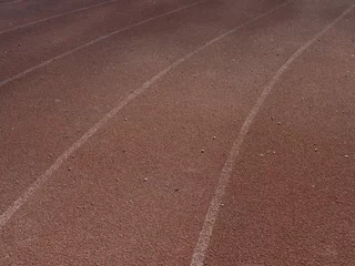 Gordijnen Close-up texture of rubberized running track on stadium with marked lanes. © Stanislav