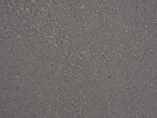 Close-up and top view to rubberized grey running track on stadium with textured surface.