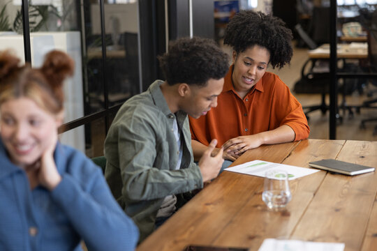 Team leader listening to new employee present an idea