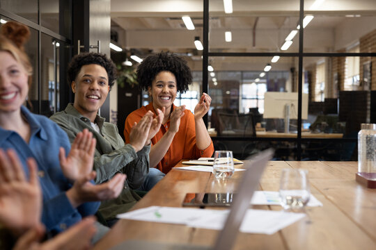 Team Applauding During Engaging Meeting Session